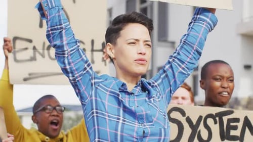 Adults protesting with signs in urban environment
