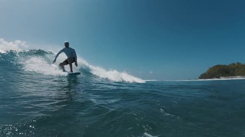 Surfer rides the ocean wave in the Maldives