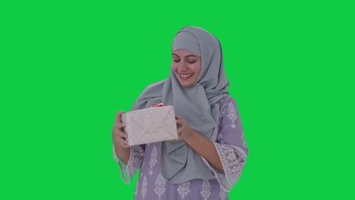 Muslim woman receiving a gift Green screen