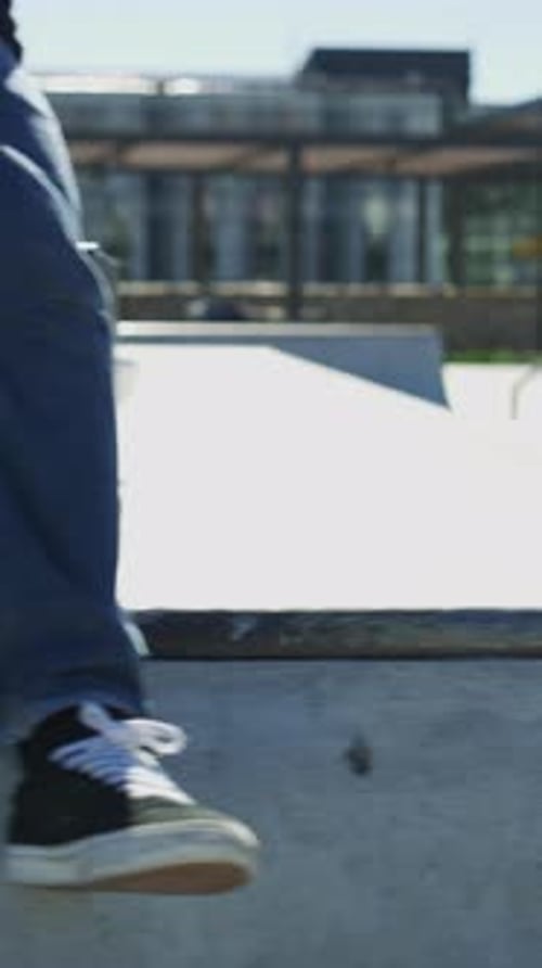 Skateboard, legs and chill with friends on ramp in skatepark for relax, hobby or balance