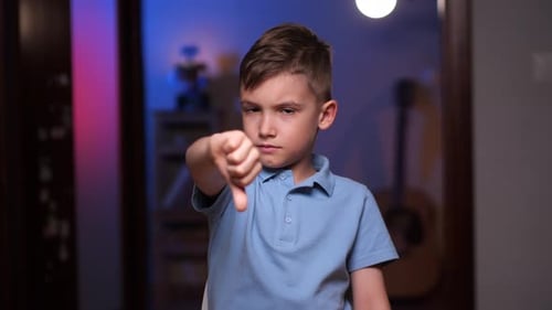 Boy Gives Thumbs Down Gesture