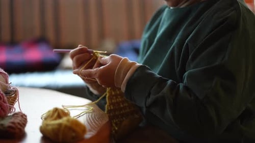 Adult Knitting inside with Yellow Yarn