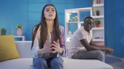 Woman Arguing with Man on Couch in Living Room