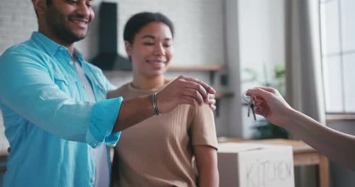Happy Couple Receives Key to New Apartment From Agent