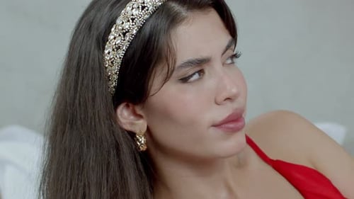 Glamorous Woman with Jeweled Headband Posing in Home