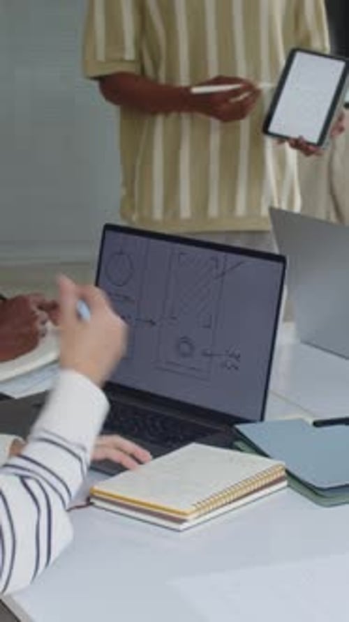 Male Developer Presenting App Interface for Coworkers