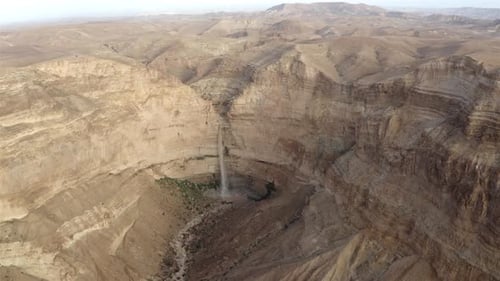 Giant waterfall, flash flood, Water falling into a pool in Wadi-Aerial