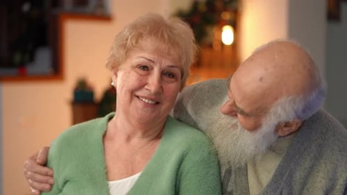 Loving Elderly Couple Smiling in a Home