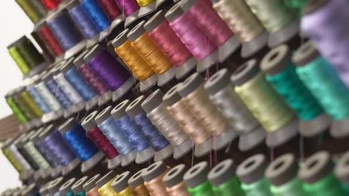 Close Up Shot Of Colourful Spools Of Sewing Cotton Thread In A Textiles Production Factory.