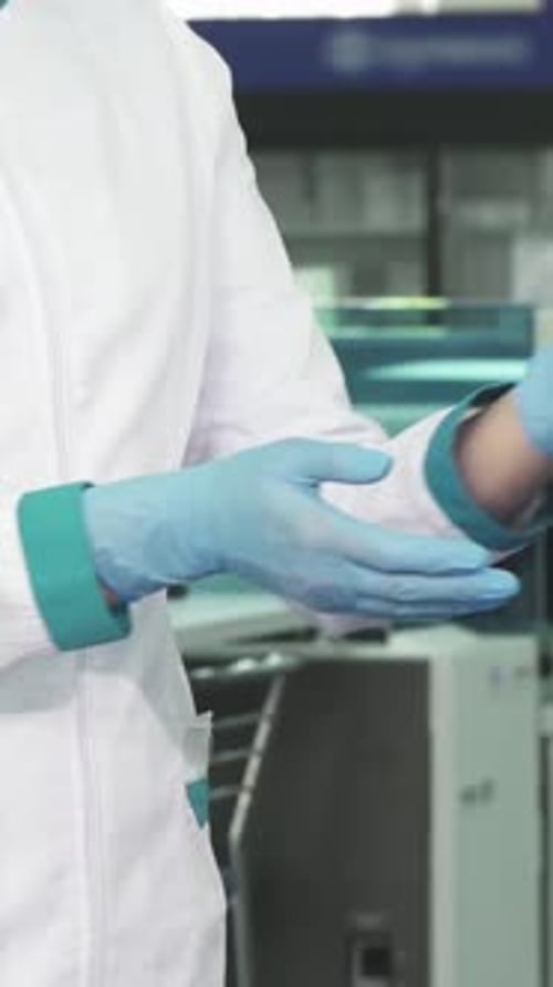 Medical Professional Examines Vials in Laboratory