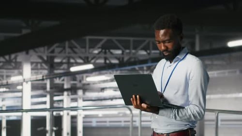 Data Center Coworkers Use Laptop to Monitor Neural Network LLM Visualization