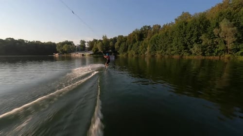 Aerial FPV Drone View of Female Wakeboard Surfer in Helmet Performing Bad Jump Trick and Falling