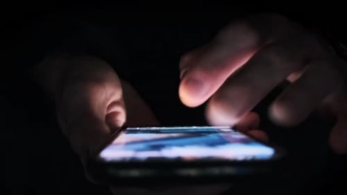 Fingers Using Mobile Phone Screen in Dark