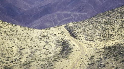 Aerial View of Winding Desert Road in Mountains