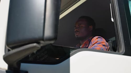 Man Sitting in the Cabin of a Truck