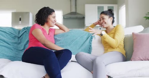 Two Women Chatting on a Couch, Laughing