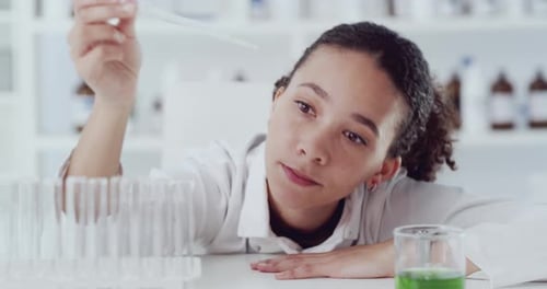 Woman Pipetting Liquid in Scientific Laboratory