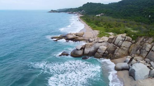 Sea view of Santa Marta, Columbia where blue water waves are crashing with giant rock, Santa Marta,