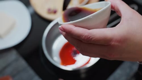 Adding Rich Sauce to Pan on Modern Stovetop