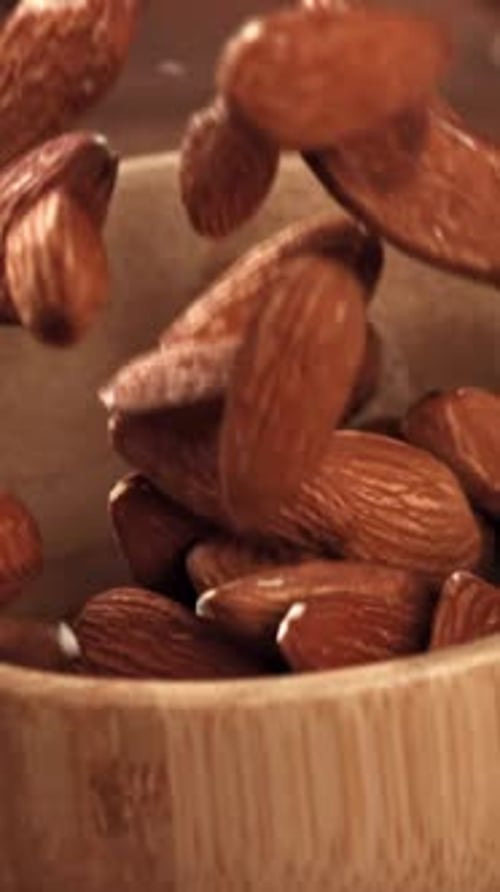 The Almonds Fall Into a Wooden Bowl Filmed on a Highspeed Camera at 1000 Fps
