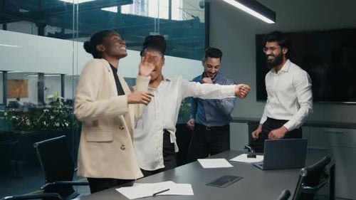 Cheerful Colleagues Celebrate in Modern Office