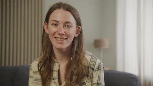 Smiling Woman Posing in an Indoor Environment