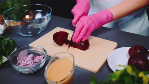 Cutting Beetroot Into Pieces on a Cutting Board