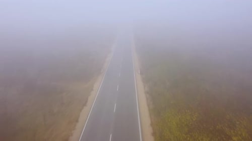 Asphalt Road Highway in an Autumn Fog Forest Aerial View