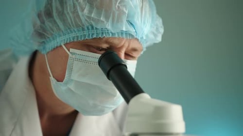 Middleaged Laboratory Scientist Starts Doing Laboratory Research on Microscope