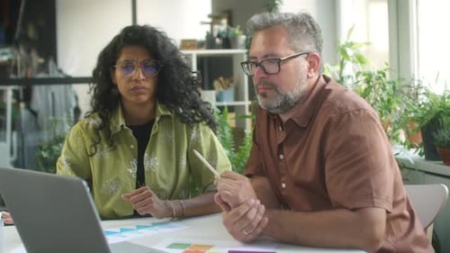 Diverse Colleagues Analyzing Data in Bright Workplace
