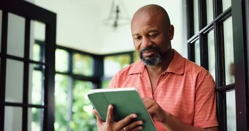 Man Using Tablet in Bright Home Entryway