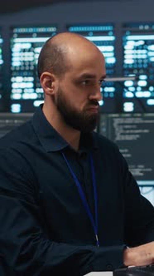 Vertical Video Technician Using PC in High Tech Server Hub Facility to Safeguard Data