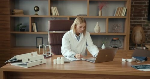 Female Doctor in Uniform Working at Office