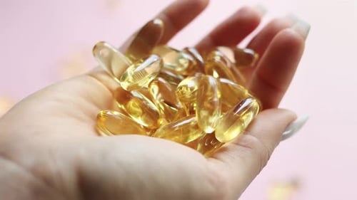 Close-up medicine yellow transparent pills, omega 3 fish oil capsules, vitamin D
