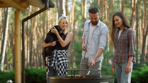Friends Grilling and Playing with Dog in Forest