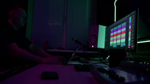 professional sound recording studio sound engineer or music producer sitting at the remote control