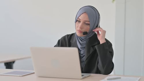 Arab Businesswoman with Headset Talking with Customers Online in Call Centre