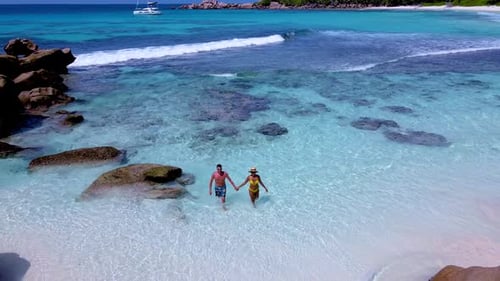 Magical Moments in the Crystal Clear Waters of Seychelles with Loved Ones on a Sunny Day