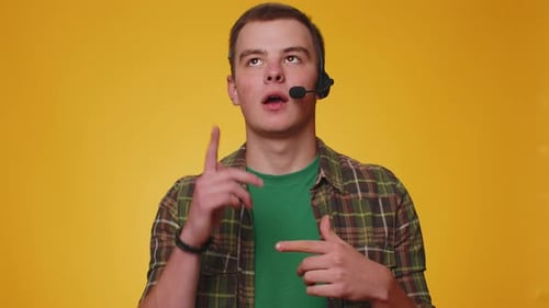 Young Man Freelance Worker Call Center or Support Service Operator Helpline Having Talk with Client