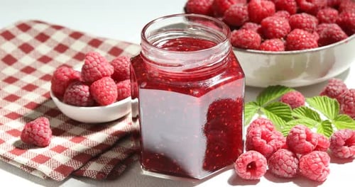 Raspberry Jam Preparation: Spoon Scooping Homemade Preserve