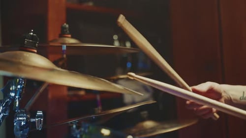 Drummer Performing in an Intimate Studio Setting During a Late Evening Session