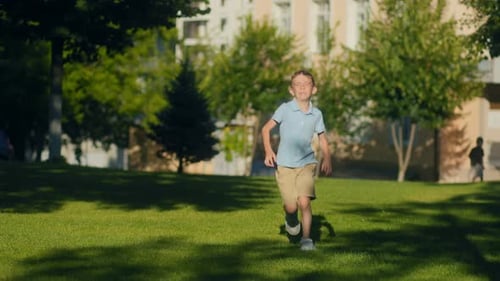 Little Kid Full of Joy Running Through Grass Near the School Grounds