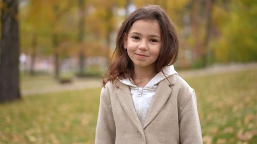 Girl Blowing a Kiss in the Fall Park