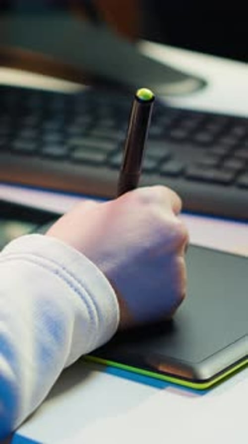 Hand Using Stylus on a Graphic Tablet