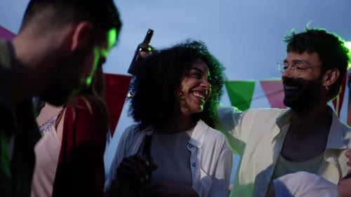 Young Adults Dancing at Nighttime Rooftop Party