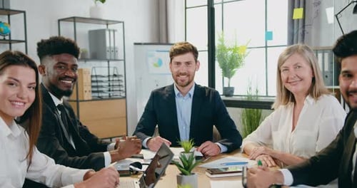 Diverse Team Smiling at Office Meeting