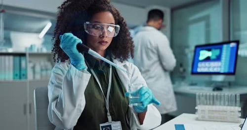 Woman Uses Pipette in Bright Modern Laboratory