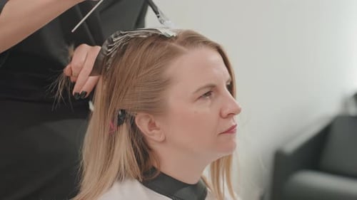 Woman Receiving Hair Treatment in Beauty Salon