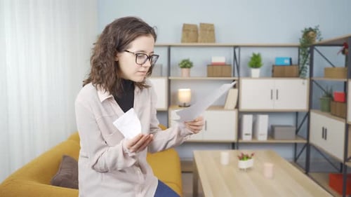 Woman Reacts to Bad News, Tears Paper