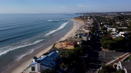 A stunning aerial drone shot, flying over beautiful beach houses towards the ocean, Solana Beach - S